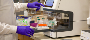 A technician processes COVID tests.